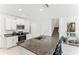 Bright open kitchen featuring granite countertops, stainless steel appliances, and white cabinetry at 4323 Trotters Way, Lakeland, FL 33801