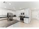 Modern kitchen with white cabinets, stainless steel appliances, and granite countertops at 4323 Trotters Way, Lakeland, FL 33801