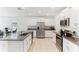 Open kitchen featuring a granite island, stainless steel appliances, and white cabinetry at 4323 Trotters Way, Lakeland, FL 33801