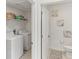 Laundry room with washer, dryer, wire shelves, and adjacent half bathroom at 4323 Trotters Way, Lakeland, FL 33801