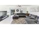 Comfortable living room area with plush sectional seating and a sliding glass door to the backyard at 4323 Trotters Way, Lakeland, FL 33801