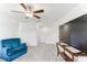 Open loft with carpet, tv, ceiling fan, and a blue armchair at 4323 Trotters Way, Lakeland, FL 33801