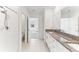 Bright bathroom with double sinks, granite countertop, and shower with tile surround at 4323 Trotters Way, Lakeland, FL 33801