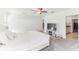 Bright main bedroom with open doorway to bathroom and closet, ceiling fan and TV at 4323 Trotters Way, Lakeland, FL 33801