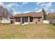 Brick home exterior with a screened patio, a grill, an attractive vase, and a well-maintained lawn at 8465 Split Creek Cir, Lakeland, FL 33809