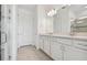 Bathroom features a double vanity, a large mirror, and a glass-enclosed shower at 8731 Sw 57Th Ln, Ocala, FL 34481