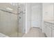 Bathroom featuring a glass-enclosed shower with decorative tiles and a vanity with storage at 8731 Sw 57Th Ln, Ocala, FL 34481