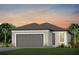 Charming single-Gathering home with a two-car garage and well-maintained lawn, set against a beautiful sunset at 8731 Sw 57Th Ln, Ocala, FL 34481