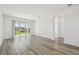 Bright living room features wood-look floors, neutral walls, and sliding glass doors to the backyard at 8731 Sw 57Th Ln, Ocala, FL 34481