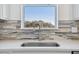 Close-up of kitchen sink with stylish faucet and a decorative tile backsplash at 8731 Sw 57Th Ln, Ocala, FL 34481