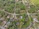 Birds-eye view of the neighborhood highlighting the property's placement in a community surrounded by trees at 10774 Sw 185Th Ter, Dunnellon, FL 34432