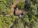 Aerial view of a home with a fenced-in backyard surrounded by tall, mature trees at 10774 Sw 185Th Ter, Dunnellon, FL 34432