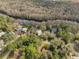 Aerial view showcasing the community, homes, and the Santa Fe River winding along a wooded area at 10774 Sw 185Th Ter, Dunnellon, FL 34432