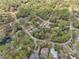 Aerial view showcases the community, nestled amongst the trees, with winding roads at 10774 Sw 185Th Ter, Dunnellon, FL 34432