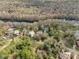 Aerial view showcasing the community, homes, and the Santa Fe River winding along a wooded area at 10774 Sw 185Th Ter, Dunnellon, FL 34432