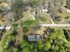 An aerial shot of a house surrounded by trees and other homes in the distance at 10774 Sw 185Th Ter, Dunnellon, FL 34432