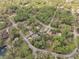 An aerial view showcases a neighborhood nestled among mature trees and winding roads at 10774 Sw 185Th Ter, Dunnellon, FL 34432