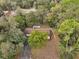 Aerial view of the property showcasing the home's placement among mature trees at 10774 Sw 185Th Ter, Dunnellon, FL 34432