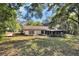 Expansive backyard featuring a screened-in porch and mature trees for added privacy at 10774 Sw 185Th Ter, Dunnellon, FL 34432