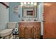 Bright bathroom featuring a wood vanity, toilet, and plenty of room at 10774 Sw 185Th Ter, Dunnellon, FL 34432