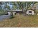 Charming single-story home with stone accents, a spacious front yard, and a large shade tree at 10774 Sw 185Th Ter, Dunnellon, FL 34432