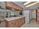 Spacious kitchen featuring an open layout, a breakfast bar, and a brick accent wall at 10774 Sw 185Th Ter, Dunnellon, FL 34432