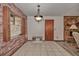 Inviting living room with brick wall, fireplace, tile flooring, and modern lighting at 10774 Sw 185Th Ter, Dunnellon, FL 34432