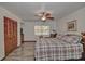 Comfortable bedroom with wood-look flooring, ceiling fan, and closet space at 10774 Sw 185Th Ter, Dunnellon, FL 34432