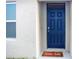 Inviting entryway with a stylish blue door and a 'Hello Fall' themed welcome mat at 469 Liu Ln, Deland, FL 32724