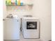 Functional laundry room featuring a modern washer and dryer set with a wire rack shelf above at 469 Liu Ln, Deland, FL 32724