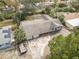 Aerial view of the single Gathering home surrounded by a driveway and mature trees at 2001 Cricket Dr, Orlando, FL 32808