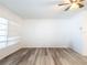 Clean and spacious bedroom with new wood-look flooring, crown molding, and bright natural light at 2001 Cricket Dr, Orlando, FL 32808