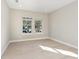 Well-lit bedroom featuring two windows with neighborhood views, and light walls and flooring at 2308 Depauw Ave, Orlando, FL 32804