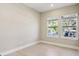 Bright bedroom with two windows offering natural light and views of the neighborhood at 2308 Depauw Ave, Orlando, FL 32804