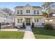 Inviting two-story white home boasts a manicured lawn, walkway, covered porch, and a welcoming entrance at 2308 Depauw Ave, Orlando, FL 32804