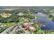 Stunning aerial view of the community clubhouse, pool, tennis courts, and a serene lake at 439 Toldedo Rd, Davenport, FL 33837