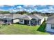 Overhead view of the property with a green backyard, screened lanai, and mature landscaping at 439 Toldedo Rd, Davenport, FL 33837