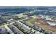 Overhead shot showcasing the layout of the homes in the community with a picturesque lake at 439 Toldedo Rd, Davenport, FL 33837