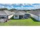 High-angle shot of the property, showcasing the backyard, screened patio, and well-manicured lawn at 439 Toldedo Rd, Davenport, FL 33837