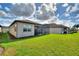 Lush backyard with a screened lanai, providing ample space for outdoor activities and entertaining at 439 Toldedo Rd, Davenport, FL 33837