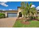 Charming single-Gathering home with a two-car garage and a well-manicured front yard with shrubs at 439 Toldedo Rd, Davenport, FL 33837