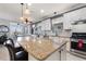 Kitchen island with granite countertop and pendant lighting, open to the dining area at 439 Toldedo Rd, Davenport, FL 33837