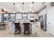 Well-lit kitchen featuring an island with barstool seating and stainless steel appliances at 439 Toldedo Rd, Davenport, FL 33837