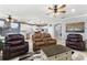 Inviting living room featuring leather furniture and an open concept view into the kitchen at 439 Toldedo Rd, Davenport, FL 33837