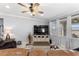 Cozy living room filled with natural light and featuring leather seating, a ceiling fan, and stylish decorations at 439 Toldedo Rd, Davenport, FL 33837