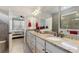 Bright bathroom featuring double sinks with granite countertop, and a bedroom doorway view at 439 Toldedo Rd, Davenport, FL 33837