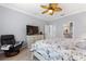 Bright main bedroom showcasing a ceiling fan, and a relaxing chair with a dresser at 439 Toldedo Rd, Davenport, FL 33837