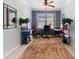 Cozy home office with ample storage shelves, a neutral-toned rug, and a ceiling fan at 439 Toldedo Rd, Davenport, FL 33837