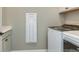 Convenient laundry area with appliances and cabinetry for efficient laundry care at 5230 Sw 88Th Cir, Ocala, FL 34481