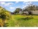 Beautiful backyard featuring well-manicured lawn, landscaping, and a screened-in patio at 1006 Breggia Ct, Haines City, FL 33844